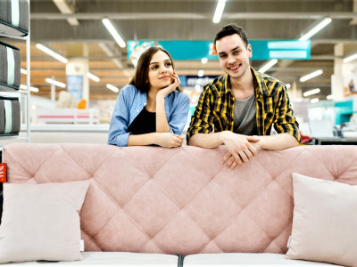 young-love-couple-poses-at-the-pink-couch-in-furniture-store.jpg
