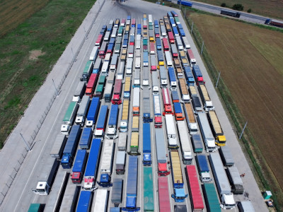 a-pattern-of-many-trucks-taken-down-from-a-height-trucks-lined-up-to-unload-grain-at-the-port.jpg