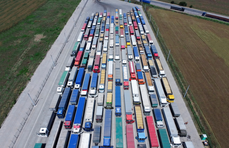 a-pattern-of-many-trucks-taken-down-from-a-height-trucks-lined-up-to-unload-grain-at-the-port.jpg