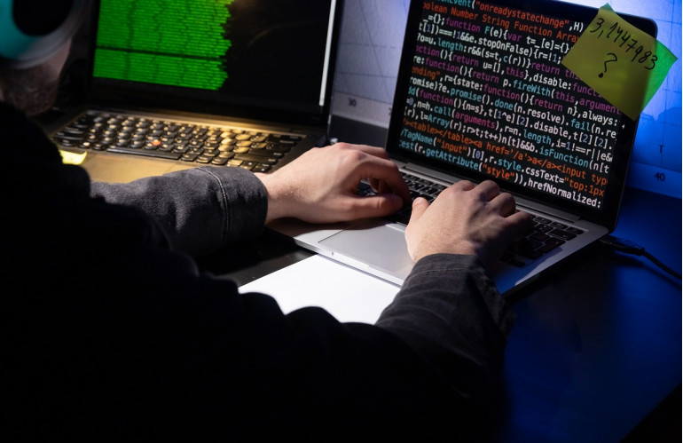 close-up-of-man-planning-hacker-attack-in-dark-room.jpg