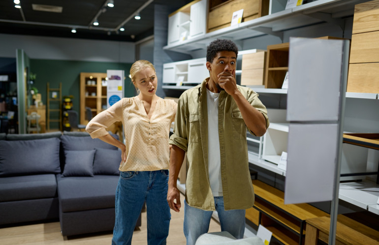 couple-disappointed-with-price-in-furniture-store.jpg
