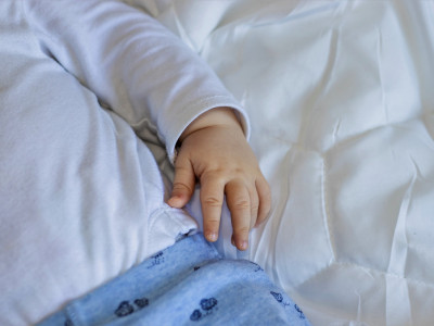 close-up-of-baby-little-hand-on-white-soft-blanket-toddler.jpg