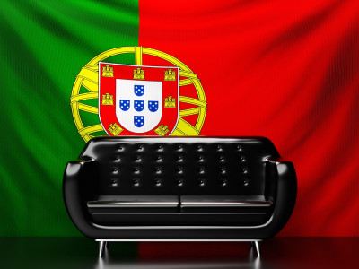 black-leather-sofa-with-the-national-flag-of-portugal-in-the-background.jpg