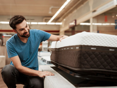 handsome-man-choosing-mattress-in-furniture-store.jpg